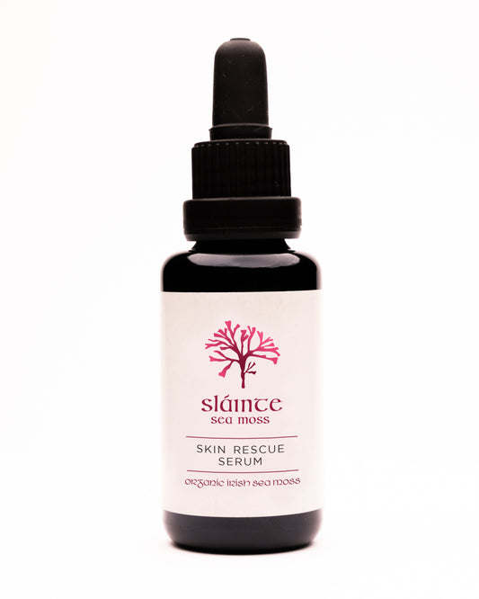 A bottle of Skin Rescue Serum by Sláinte, with a dropper, on a white background.